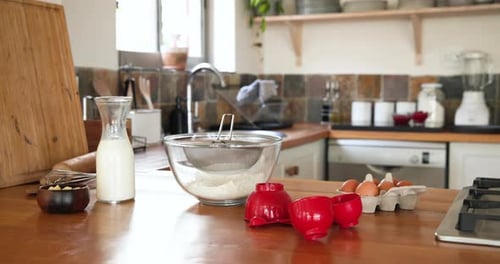 Mehl, Milch und Eier mischen, Frau bereitet Nachtisch in der gemütlichen Küche zu