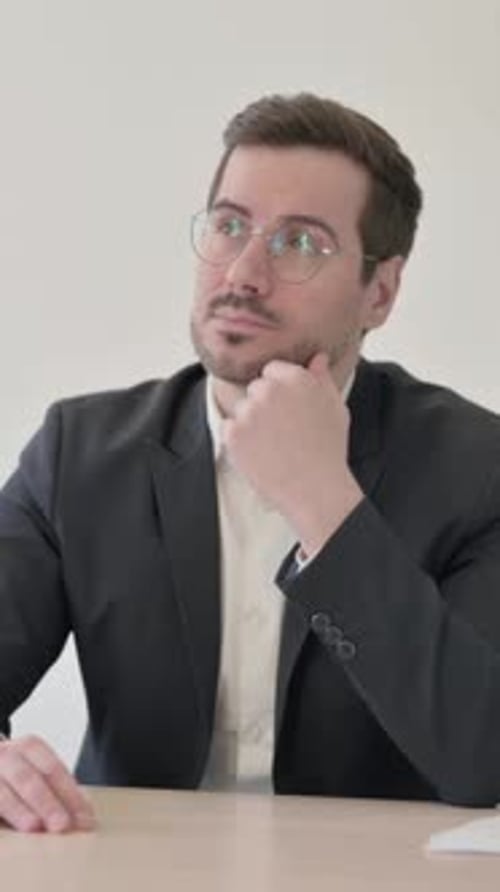Pensive Businessman Thinking while Sitting at Work, vertical video