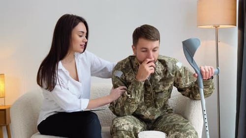 Distressed Man in Military Camo Receives Support