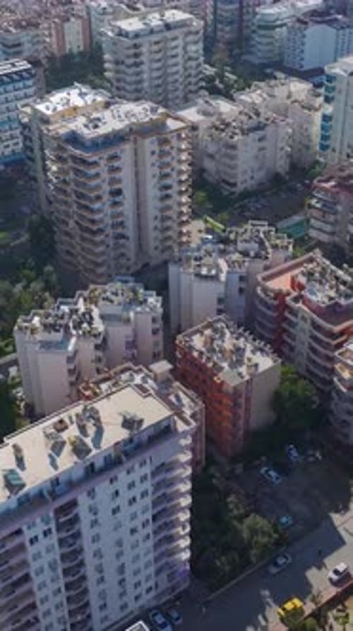 Vertical Video of a Cityscape Captured From the Sky With Urban Roads and Buildings Stretching Across