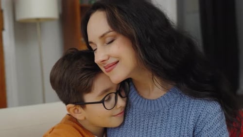 Loving Mother and Child Embracing Comfortably Indoors