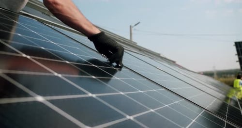 Workers Installing Solar Panels on a Sunny Day