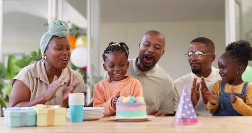 Family Celebrates Birthday with Cake at Home