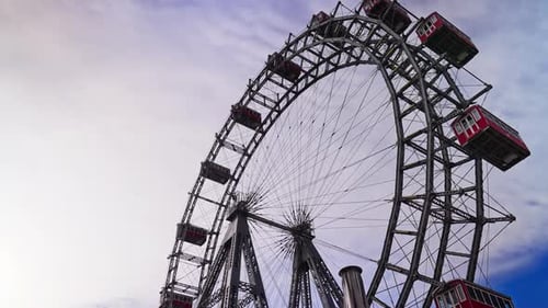 The historic Giant Ferris Wheel spinning, Wiener Riesenrad, at the Prater Park in Vienna, Austria
