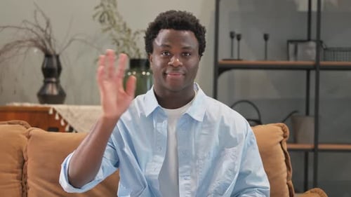 Portrait of African Man Waving Hand to Welcome at Home