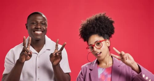 Face, smile and couple with peace sign in studio for victory, success or fashion on red background