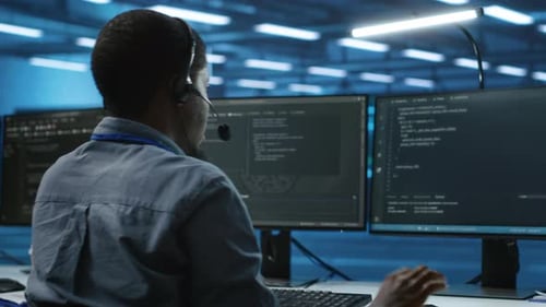 IT Support Worker in Data Center Talking in Headset Mic with Coworkers