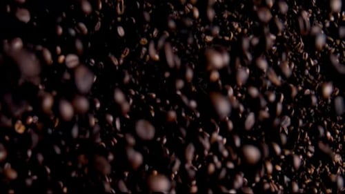 Coffee grains avalanche aromatic roasted arabica beans downfall in super slow motion