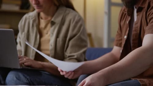 Couple Reviews Documents Together at Home