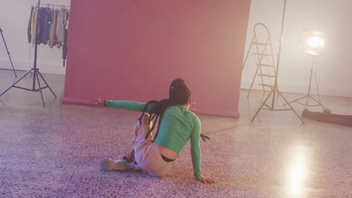Portrait of biracial female dancer dancing in dance studio, slow motion