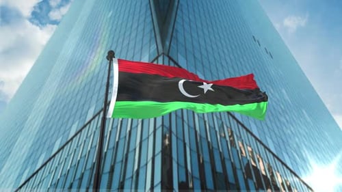 Libyan Flag Waving on Flagpole with Modern Skyscraper Background