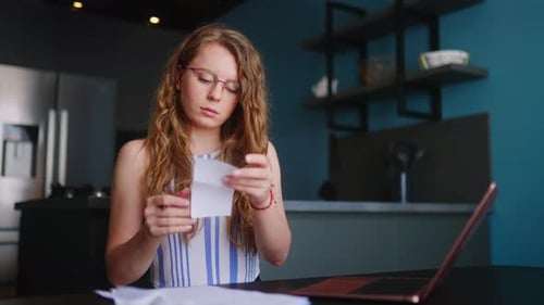 Woman working on laptop computer at home