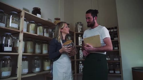 Shop assistants talking about sustainability in zero waste grocery store