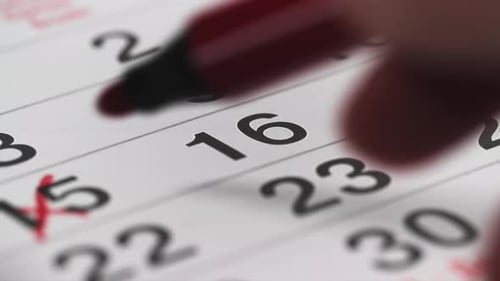 Marking Days on Calendar with Red Marker