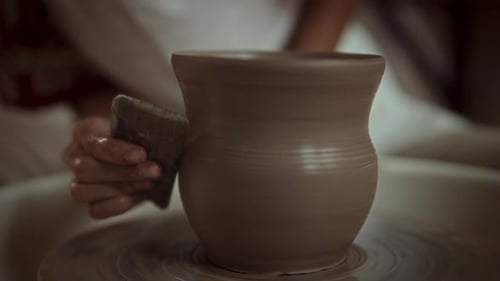 Potter Shaping Clay Pot on Spinning Wheel