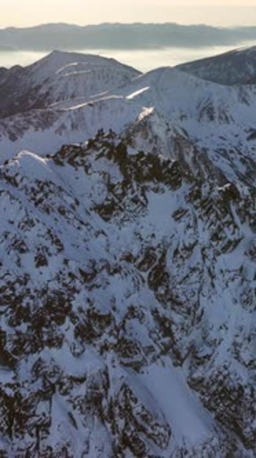 Exploring the majestic snow-covered peaks of the Alps in vertical view