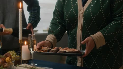 Preparing Christmas Dinner with Candles and Champagne