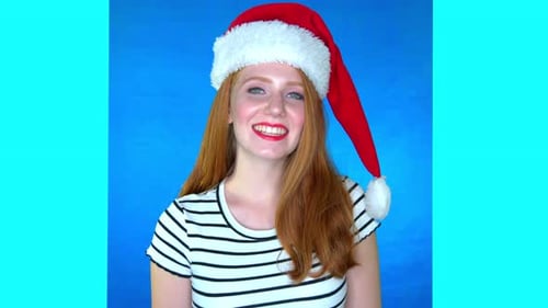 Smiling Woman in Santa Hat on Blue Background