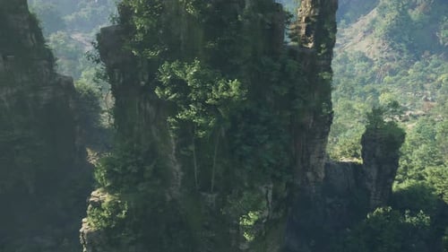 Rock Formation Adorned with Lush Trees in the Picturesque Landscape of China