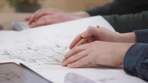 Architects Reviewing Blueprints Together in an Office Setting