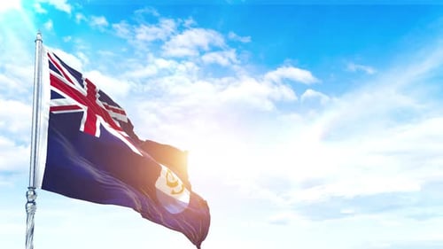 Anguilla Flag Waving in Sunlight Against Blue Sky