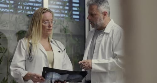 Doctors Reviewing Patient's X-Ray in Hospital Setting