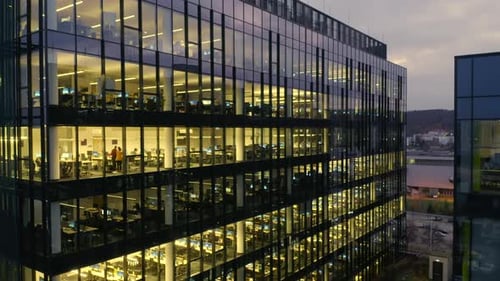 Skyscraper Facade at Night Office Windows Illuminated at Dusk