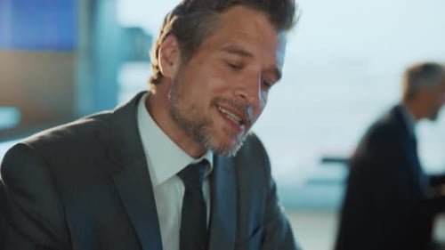 Confident Man Speaks at Business Meeting in Office