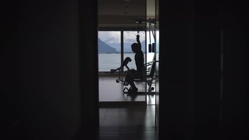 Silhouette of a Person Engaged in Exercising Against a Beautiful Scenic View Around Them