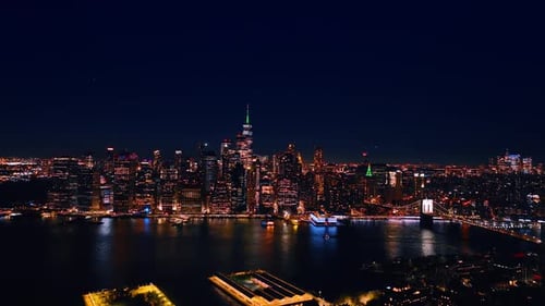 Approaching the skyline of vibrant New York with amazing illumination. Vast city panorama at night.