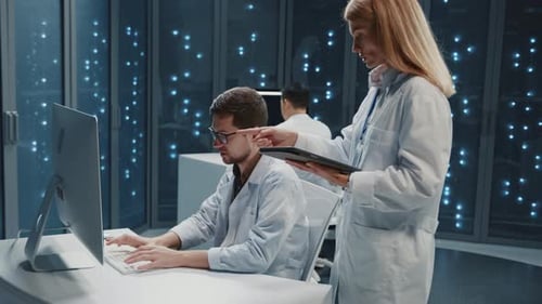 Data Center Technology Female Digital Specialist Cooperating with Male Technician Using Tablet and