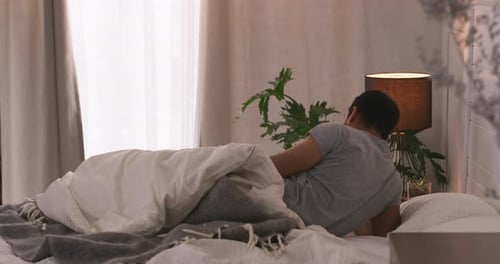 Young Adult Waking Up and Getting Out of Bed