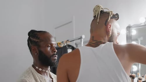 Stylish Man Getting Makeup Applied by Artist