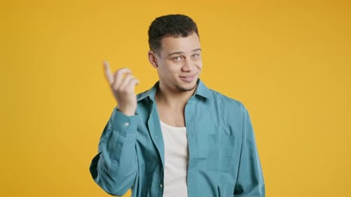 Confident Young Man Smiling in Blue Shirt