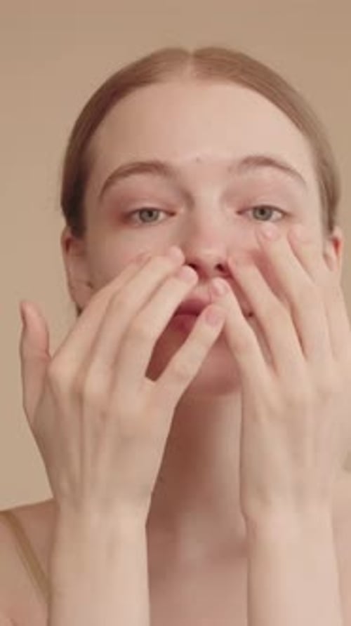 Young Woman Massaging Face for Skincare Routine