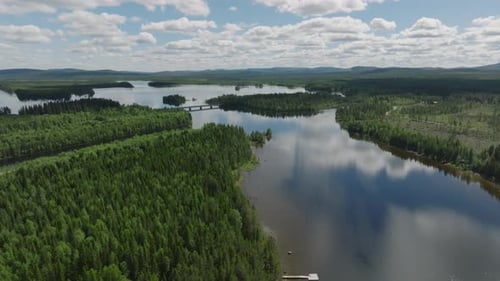 Aerial footage of bridge and river and forest in sweden