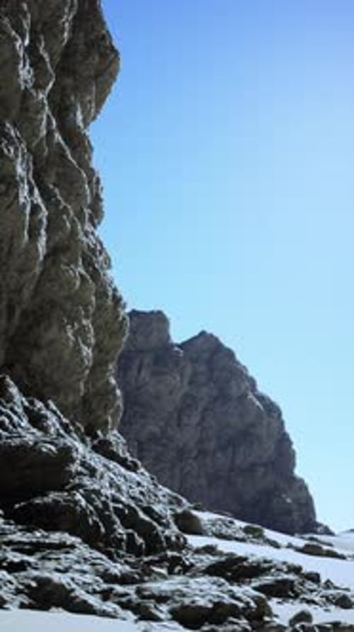 Rugged Desert Rock Formation Under Blue Sky