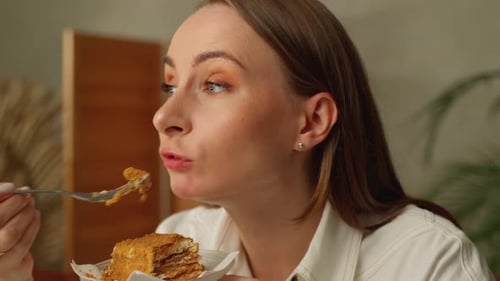 Woman Eats Delicious Cake in Close Up