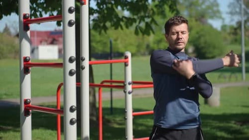 Man Stretching Before Outdoor Workout in Park Athlete Prepares for Training