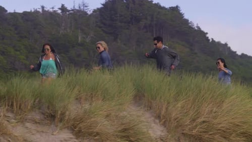 Group of Friends at Beach Running Down Grassy Trail Beach