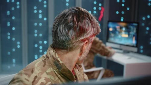 Men in Uniform Work at Computers in Office