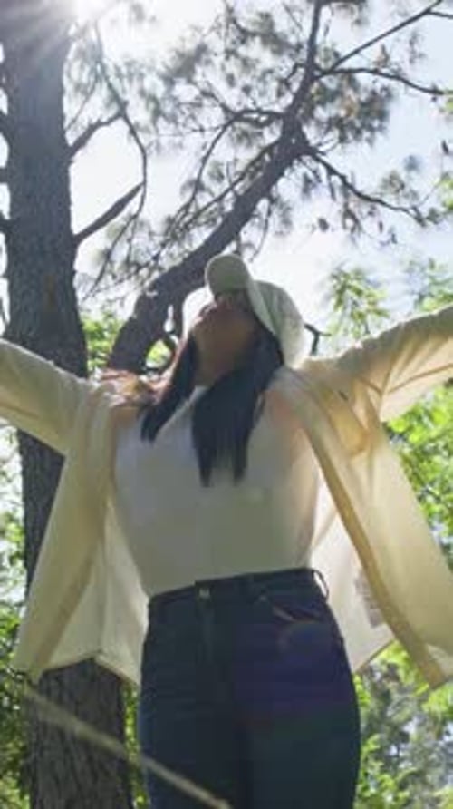 Woman Stretching Her Arms in a Forest