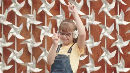 Cute Girl Enjoying Music in Headphones Outdoors