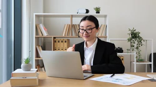 Professional Woman Working on Laptop in Bright Office