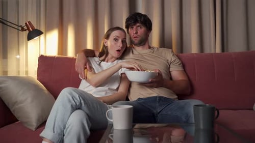 Couple Watching a Scary Movie at Home
