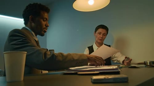 Two Professionals Reviewing Documents in Workplace