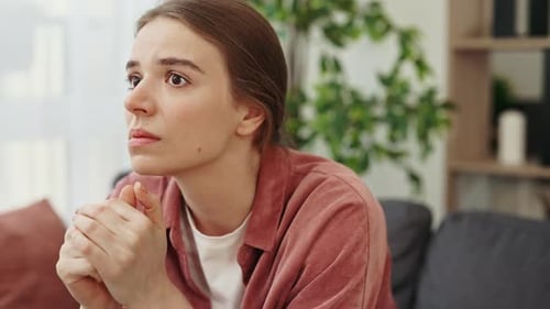 Worried Woman Seated Thinking Indoors at Home
