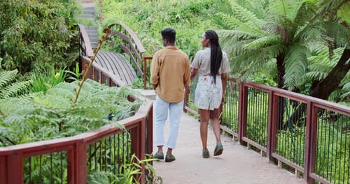 Couple Walking Hand-in-Hand in Tropical Garden