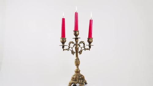 Ornate Golden Candelabra with Three Red Lit Candles