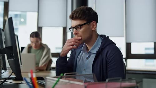 Man working at computer in office workplace